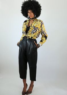 This baroque and leopard mix print is oh so retro chic and classic! It gives off an luxe vibe when paired with satin slacks or a mini leather skirt. There are so many ways to wear this little number. Impressions of California brand Size 6 Made in the Jamaica Made of Rayon Measurements in Inches: Shoulders: 16 Bust: 38 Waist: 38 Sleeve: 20.5 Mini Leather Skirt, Vintage Leopard, Retro Chic, Mixing Prints, Yellow Black, Vintage Tops, Jamaica, Leather Skirt, California