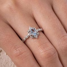 a woman's hand with a diamond ring on top of her finger and an engagement band