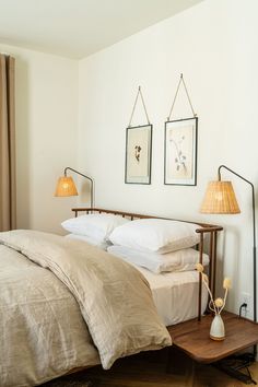 a bed with two lamps on either side of it