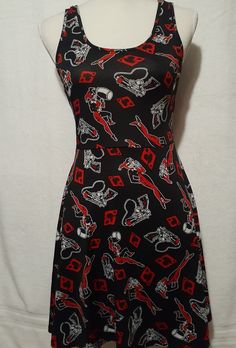 a black dress with red and white designs on it