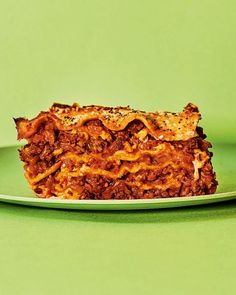 a piece of lasagna on a green plate