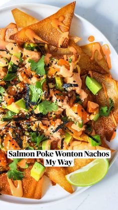 salmon pok wonton nachos on a white plate with lime wedges