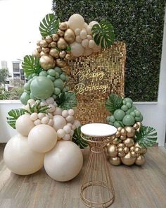 balloons and greenery are arranged on a table