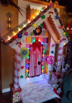 a gingerbread house decorated with candy canes and lights