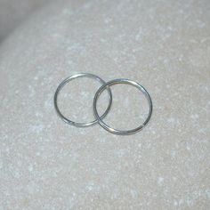 ⋙ Sterling Silver small hoop earrings. ⋙ This listing is for two earrings. ⋙ Available gauges for the earrings: 24g; 22g; 20g; 18g; 16g; 14g. ⋙ Please note: the less gauge number, the thicker earrings are. ⋙ Available interior (inner) diameters: 7mm; 8mm; 9mm; 10mm; 11mm; 12mm ⋙ I will put your order into a beautiful jewelry box (it will be ready for gift giving). Everyday Silver Round Nose Rings, Minimalist Hypoallergenic Nose Ring, Nickel Free Round Piercings For Jewelry Making, Minimalist Hoop Rings With Pierced Detail, Minimalist Hoop Rings, Minimalist Nickel Free Nose Ring, Minimalist Round Ring, Ring Nose Piercing, Hoop Nose Ring