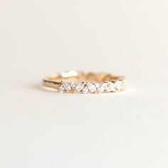 a gold wedding band with five pear shaped diamonds