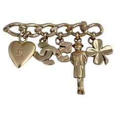 This is a charm bar brooch designed by Chanel for 2002 collection. The piece is gold plated. It features heart, CC logo, number five, madame Coco, clover charms. Signed: ©Chanel® 02P. Made in France Bar length: 6cm Width (at max): 4.5cm ——— If you have any questions, please feel free to ask. We describe our items accurately. Please note that in reality they can look much better because photo can’t capture that magical sparkle. We have many years of experience in this business. And we have a very Chanel Charm, Successful Family, Charm Bar, Logo Heart, Bar Brooch, Logo Number, David Webb, Number Five, Clover Charm