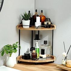 a bathroom with two shelves that have various items on them and plants in the corner