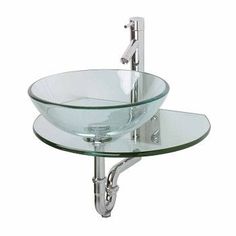 a glass bowl sink with chrome faucet and metal fittings on the side