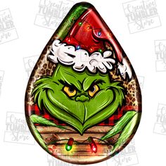 the grin face is wearing a santa hat on top of a tear shaped glass ornament