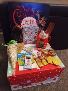 the night before christmas gift box is filled with candy, cookies and other holiday treats