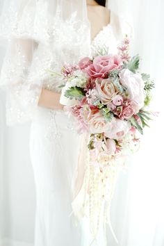 a bride holding a bouquet of flowers in her hands