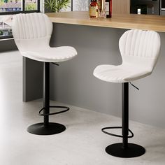 two white bar stools sitting next to each other in front of a counter top