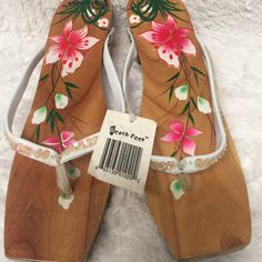 This Beach Feet Sandal Is Slip On. It's Wood With Floral Print. The Strap Are Encrusted With Iridescent Opal. It's New With Tag. Only Flaw Is Left Sandal Has A Chipped Wood And Minor Scuffs On Both Sandal. Size 8. White Toe Post Heels For Vacation, White Wedge Heel Flip Flops For Spring, Beach Wedge Sandals With Wooden Heel, Synthetic Sandals With Wooden Heel For The Beach, Summer Beach Wedge Sandals With Wooden Heel, Closed Toe Wedge Sandals With Wooden Heel For Beach, Wedge Heels With Wooden Heel For Beach, White Flat Heels For The Beach, Spring Beach Wedge Sandals With Wooden Heel