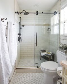 a bathroom with a shower, toilet and sink