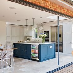 a kitchen with blue cabinets and an island