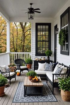 the porch is decorated with black and white furniture, potted plants, and an outdoor coffee table