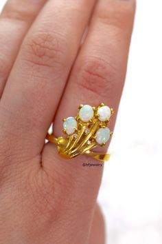 Metal: 14kt Yellow Gold Stone: Opal And Diamond Shape: Round And Oval Approximate Opal Weight: .64 ctw Approximate Diamond Weight: .06 ctw Length Of Center Of Ring: 18.67 mm Weight Of Ring Including Stones: 6.40 grams Ring Size: 7 1/2 Sizing: Please state ring size in the personalization box. Age: New item from the late 90s. It has been in our inventory since the late 1990s and has never been worn. Fine Jewelry Opal Ring With Multi-stone For Anniversary, Yellow Gold Multi-stone Opal Ring For Anniversary, 14k Gold Opal Ring With Multi-stone Round Cut, Yellow Gold Opal Ring With Brilliant Cut Diamond, Exquisite Yellow Gold Opal Ring For Anniversary, Exquisite Yellow Gold Opal Anniversary Ring, Fine Jewelry Yellow Gold Opal Ring With Brilliant Cut, Gold Opal Ring With Brilliant Cut As Gift, Luxury 14k Gold Opal Ring With Prong Setting