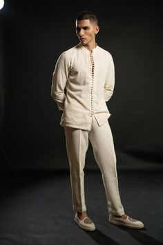 The ivory bandh gala exudes timeless elegance, crafted on silk. Its classic silhouette is adorned with intricate tonal thread embroidery, adding a touch of sophistication and refinement. Paired with a shirt boasting exquisite detailing on its buttons, the ensemble achieves a harmonious balance between tradition and modernity. Completing the ensemble are tailored pants, ensuring a seamless blend of comfort and style. This ensemble embodies understated opulence, perfect for special occasions or fo Boys Party Wear, Mens Party Wear, Kurta And Pants, Gents Kurta Design, Gents Kurta, Kurta Patterns, Wedding Outfit Men, Kurta Design, Summer Romance