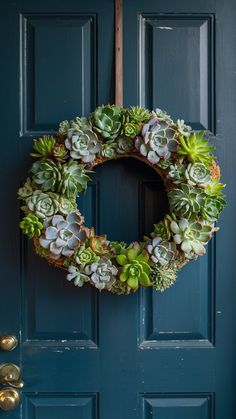 a wreath with succulents is hanging on the front door's blue door