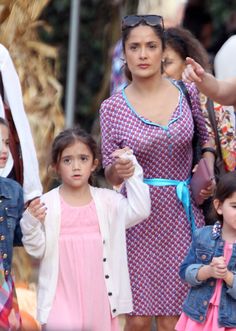 a group of women and children walking down a street