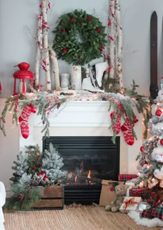 a fireplace decorated for christmas with stockings and wreaths