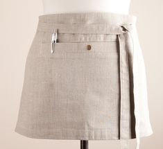 a woman's skirt on a mannequin with a belt around the waist