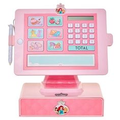 a pink toy cash register sitting on top of a table