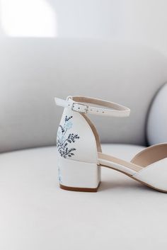 a pair of white shoes sitting on top of a table