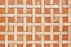 a close up view of a brick wall with different colors and patterns on it's surface