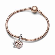 A jewelry gift for a mom who will always be perfect to you, just as she is. The Two-tone Infinity Heart Double Dangle Charm features an openwork heart dangle in 14k rose gold plating forming an infinity symbol in the center, adorned with a row of pink pavé and engraved with the word "Mom" with a pink stone as the central letter. Behind it is a sterling silver heart-shaped disc engraved with the message "To me you are perfect" creating a repeating pattern on both sides. Pink pavé on the bail adds a finishing touch. A celebration of motherly love in all its forms. Me You, Charms Pandora, Infinity Heart, Custom Pendants, Mors Dag, You Are, Infinity Symbol, Exclusive Jewelry, Engraved Necklace