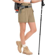 a woman is standing with her backpack and ski poles