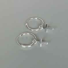 A PAIR of sterling silver hoops. Comes with a detachable dainty cross charm. The charm is multipurpose and can be used with a neck or bracelet chain too. Dimension: Hoop- 12 x 1 mm Charm- 5 x 8 mm Drop length- 20 mm Price listed is for ONE PAIR These are made of 925 hypoallergenic sterling silver. Most of my pieces come with a 925 stamp. Can be packaged in a gift box. I can include a personal message from you if needed You are welcome to contact me at... bhavnakwintra1956@gmail.com For more beau Nickel-free Cross Hoop Earrings As Gift, Dainty Handmade Silver Huggie Earrings, Hoop Charms, Evil Eye Earrings, Thread Earrings, Eye Earrings, Big Earrings, Bohemian Earrings, Sterling Silver Cross