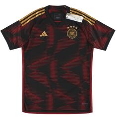 a soccer jersey that is red and black with gold stripes