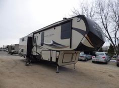 an rv parked in a parking lot next to other vehicles