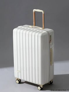 a white piece of luggage sitting on top of a table