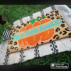 a welcome mat with an orange pumpkin on it