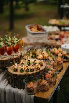 an assortment of appetizers and snacks on a table in the park or outdoors