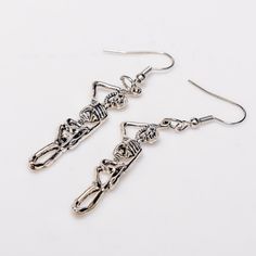 Elevate your gothic style with our Hang in There Earrings! Crafted from high-quality, hypoallergenic alloy, these 2.5-inch long earrings are designed to make a bold statement. Perfect for showcasing your unique taste, these earrings offer both style and comfort. Embrace your individuality and stand out with this stunning pair Handmade Alloy Earrings For Party, Edgy Pierced Metal Earrings, Edgy Silver Drop Earrings, Edgy Drop Earrings With Ear Wire, Edgy Metal Earrings For Party, Edgy Metal Earrings With Ear Wire, Trendy Silver Halloween Earrings, Edgy Metal Party Earrings, Trendy Pierced Metal Plug Earrings