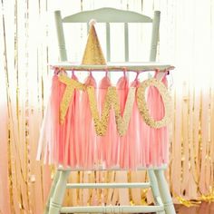 a pink and gold baby's 1st birthday party chair with the word love on it