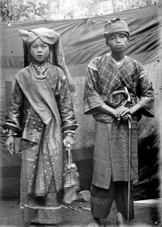 an old black and white photo of two people in native garb standing next to each other