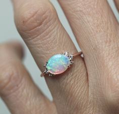 A gorgeous prong set Australian opal & diamond cluster engagement ring in 14k or 18k solid gold or platinum. The opal shines in a variety of special colors (blue, green, white, pink, ...). Lots of fire! This unique multi stone engagement, wedding or bridal cluster is available in 14k and 18k solid rose, white, yellow gold and platinum. Please select the material and ring size from the drop-down menu on the right side of the listing. If you have any questions, please send us a message. If you Ethiopian Opal Oval Ring For Wedding, Elegant Oval Pink Opal Ring, Oval Pink Opal Ring For Wedding, Oval Opal Cluster Ring For Wedding, Oval Opal Ring, Gold Opal Ring, Ruby Wedding Rings, Rose Gold Opal Ring, Australian Opal Ring