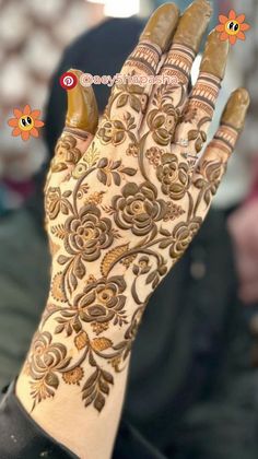 a woman's hand with henna on it