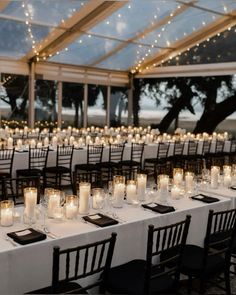 tables with candles are set up for an event