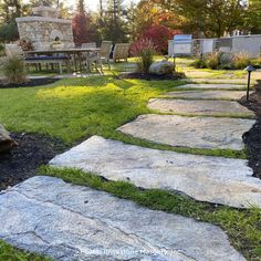 a stone path in the middle of a yard