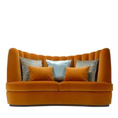 an orange couch with two pillows on top of it and one pillow in the middle