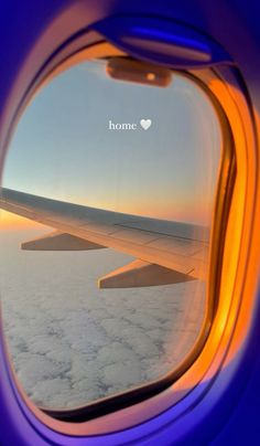 an airplane window with the view of clouds and sky from it's plane wing