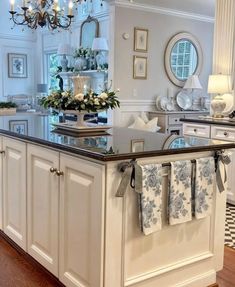 a kitchen island with towels hanging from it's sides and lights on the ceiling