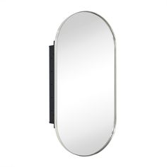 an oval mirror on the wall with a black frame and silver trim around it's edge