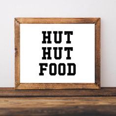 a wooden frame sitting on top of a table next to a wall with the word hutt food written in it